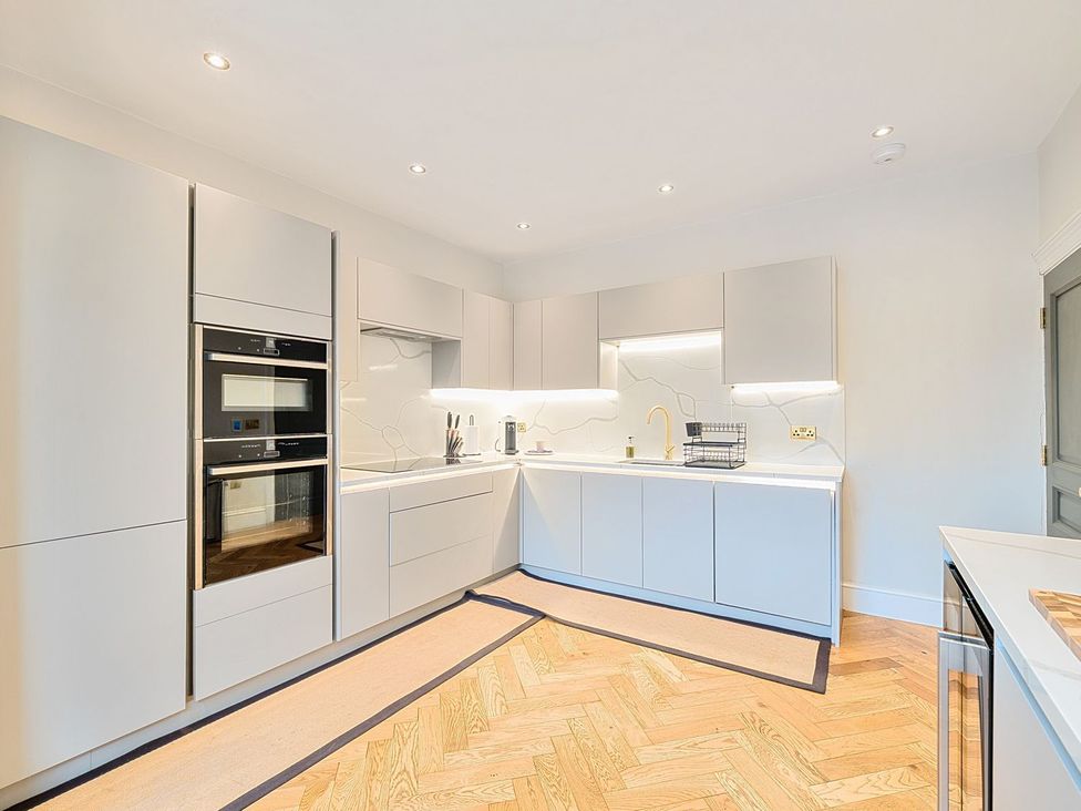 A kitchen with cabinets and appliances at Hillside House in Leyburn