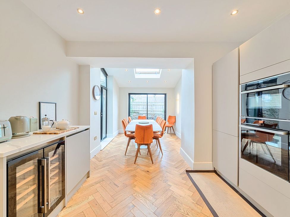 A kitchen with a dining area and modern appliances at Hillside House in Leyburn