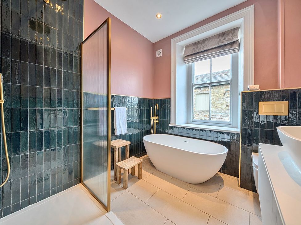 A bathroom with a bathtub and shower at Hillside House in Leyburn