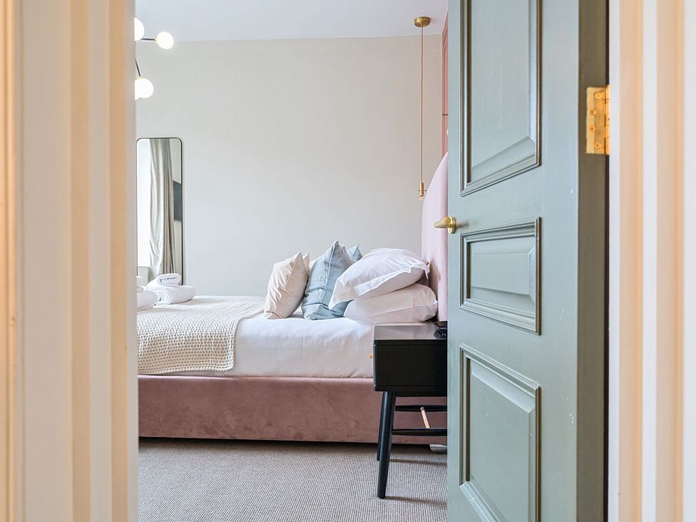 A bedroom with a bed and pillows at Hillside House in Leyburn