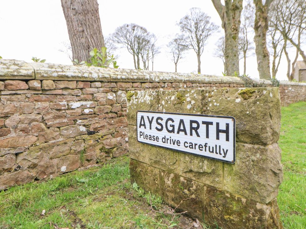A sign indicating Aysgarth with a caution to drive carefully at Hillside House Leyburn