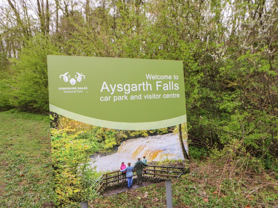 A sign for Aysgarth Falls car park and visitor centre in Yorkshire Dales National Park