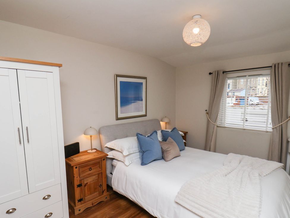 A bedroom with a bed and wardrobe at Flat 1 in Whitby