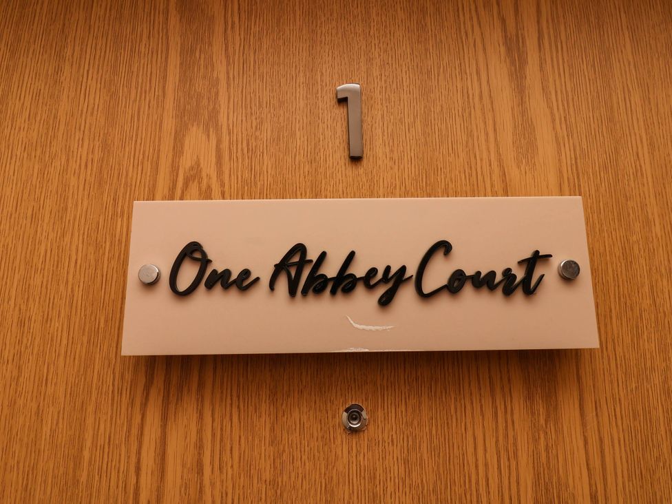 A nameplate on a door reading One Abbey Court with number 1 at Flat 1 in Whitby