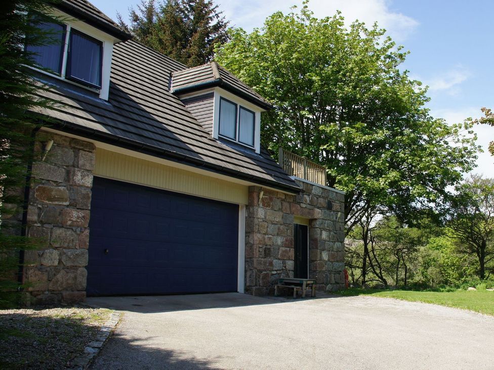 A house with a garage and trees at Boat House in Aberdeen