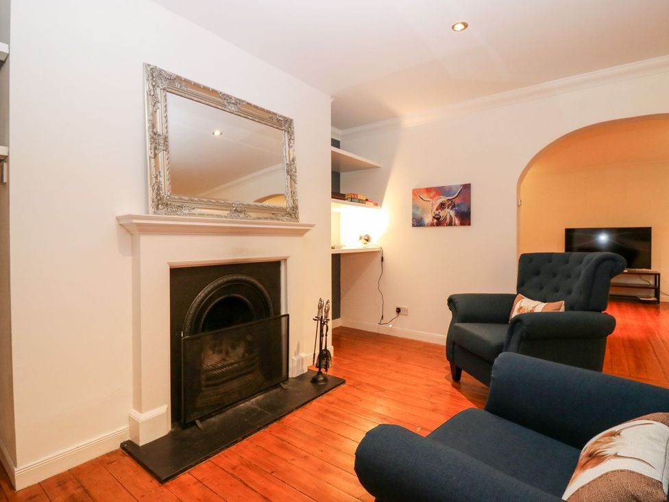 A living room with a fireplace and TV at Boat House in Aberdeen
