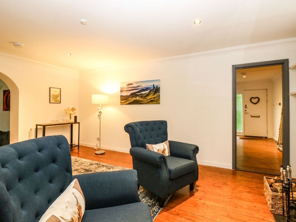 A living room with chairs and a lamp at Boat House in Aberdeen