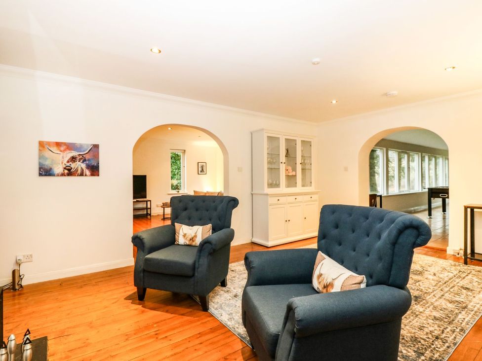 A living room with armchairs and a cabinet at Boat House in Aberdeen