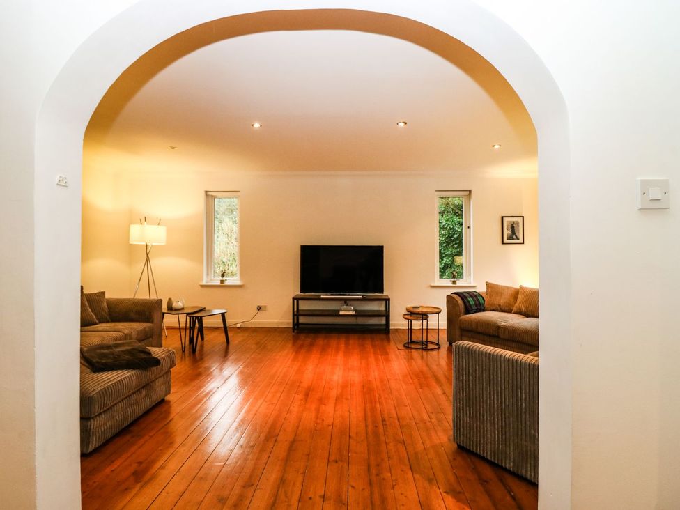 A living room with sofa and television at Boat House in Aberdeen