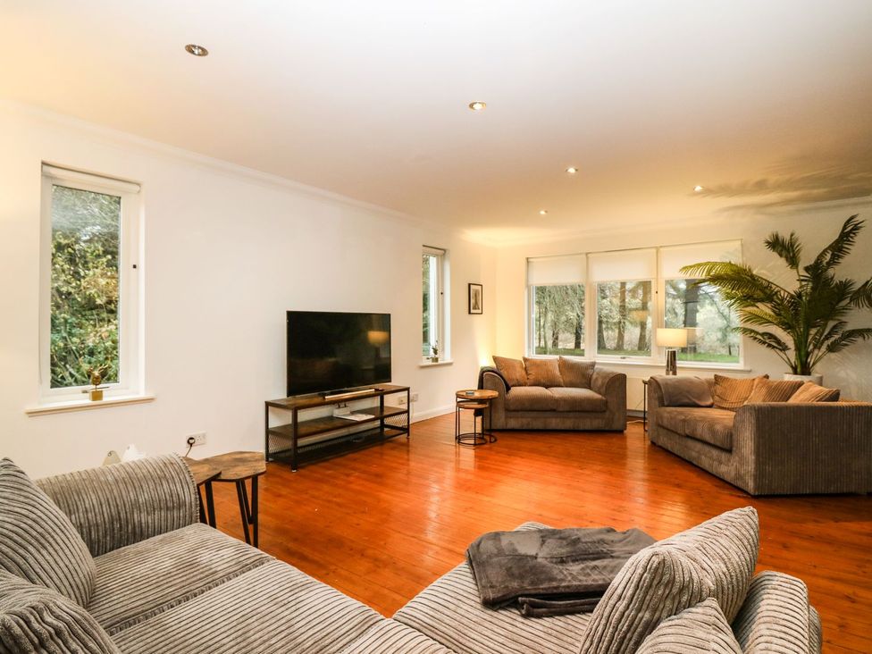 A living room with a television and two sofas at Boat House in Aberdeen