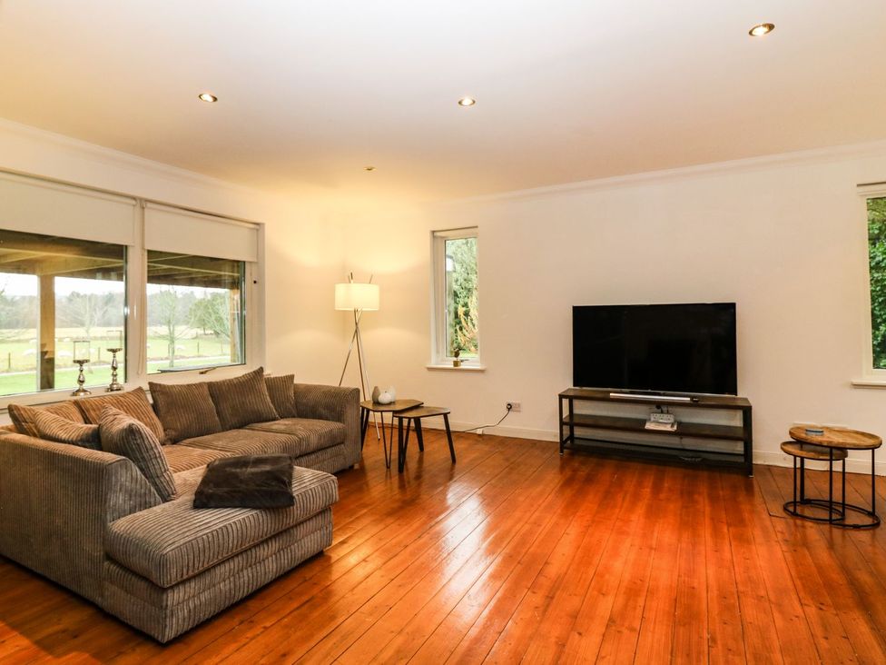 A living room with a sofa and television at Boat House in Aberdeen