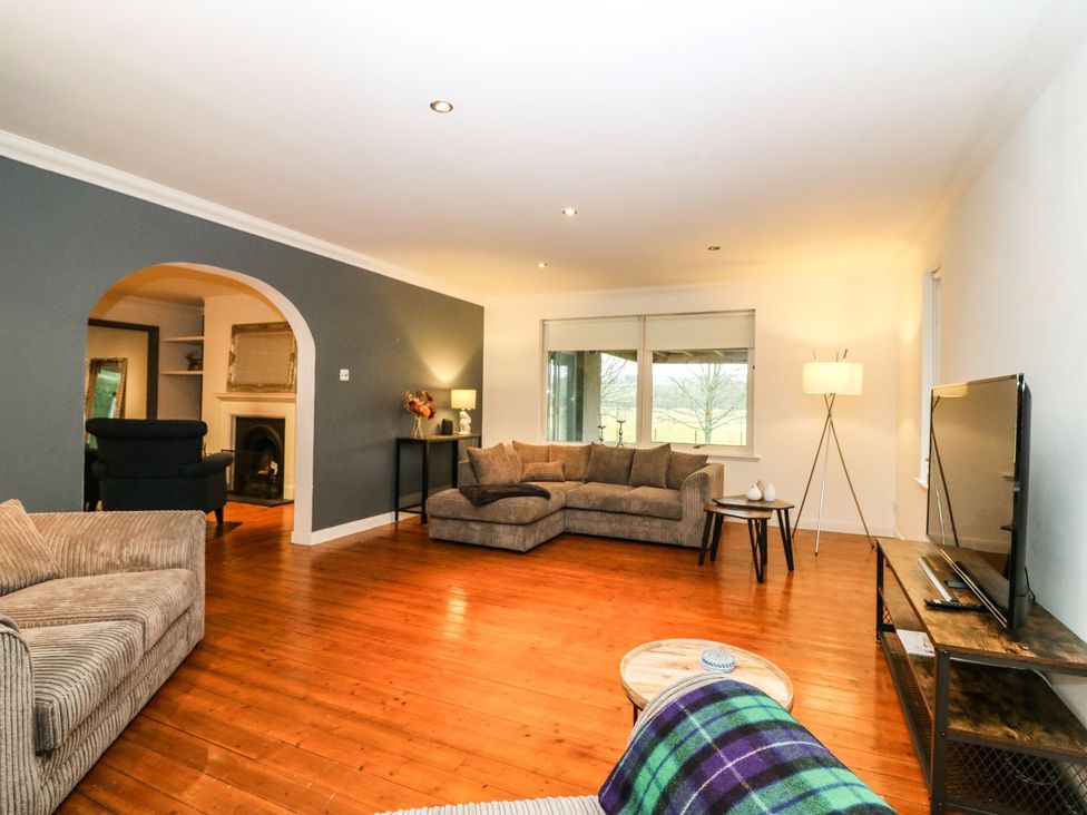 A living room with a sofa and television at Boat House in Aberdeen