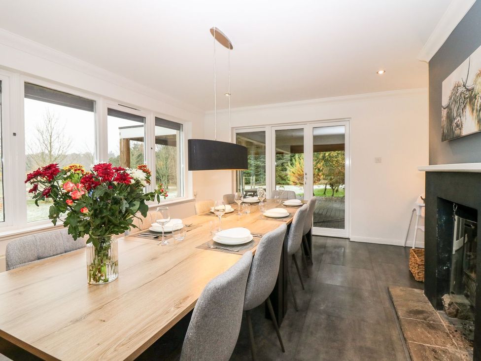 A dining room with a table and chairs at Boat House in Aberdeen