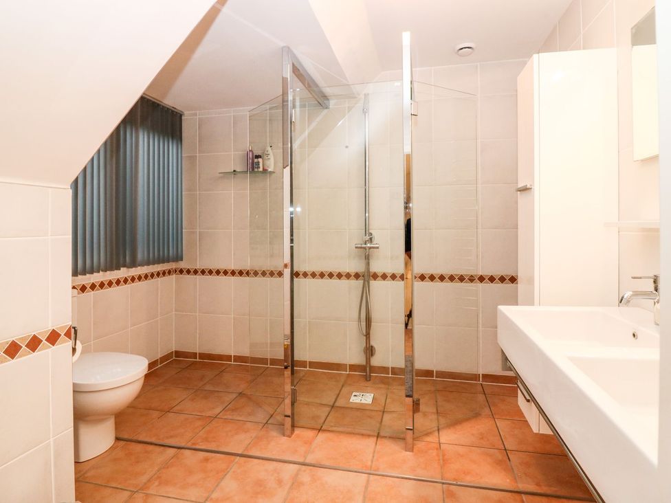 A bathroom with a shower, toilet, and sink at Boat House in Aberdeen