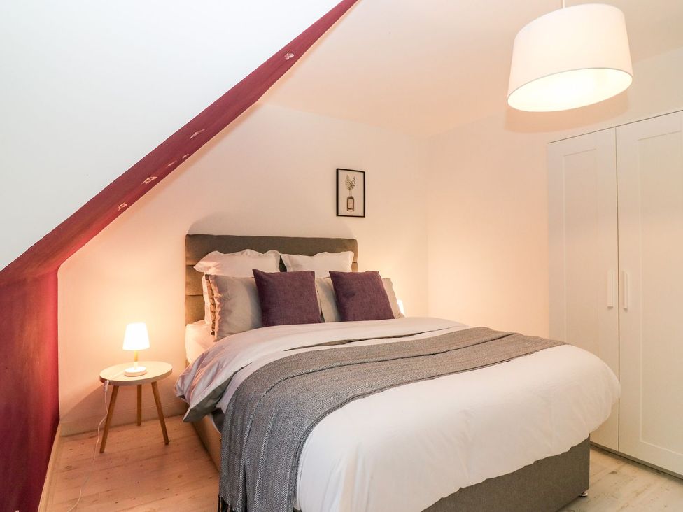 A bedroom with a bed and nightstand at Boat House in Aberdeen