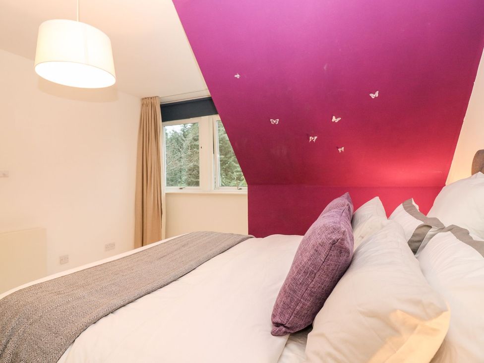 A bedroom with a bed and window at The Boat House in Aberdeen