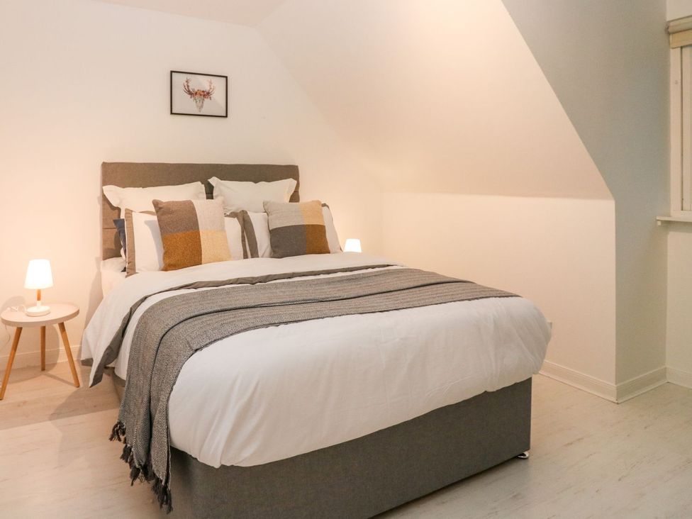 A bedroom with a bed and lamps at Boat House in Aberdeen