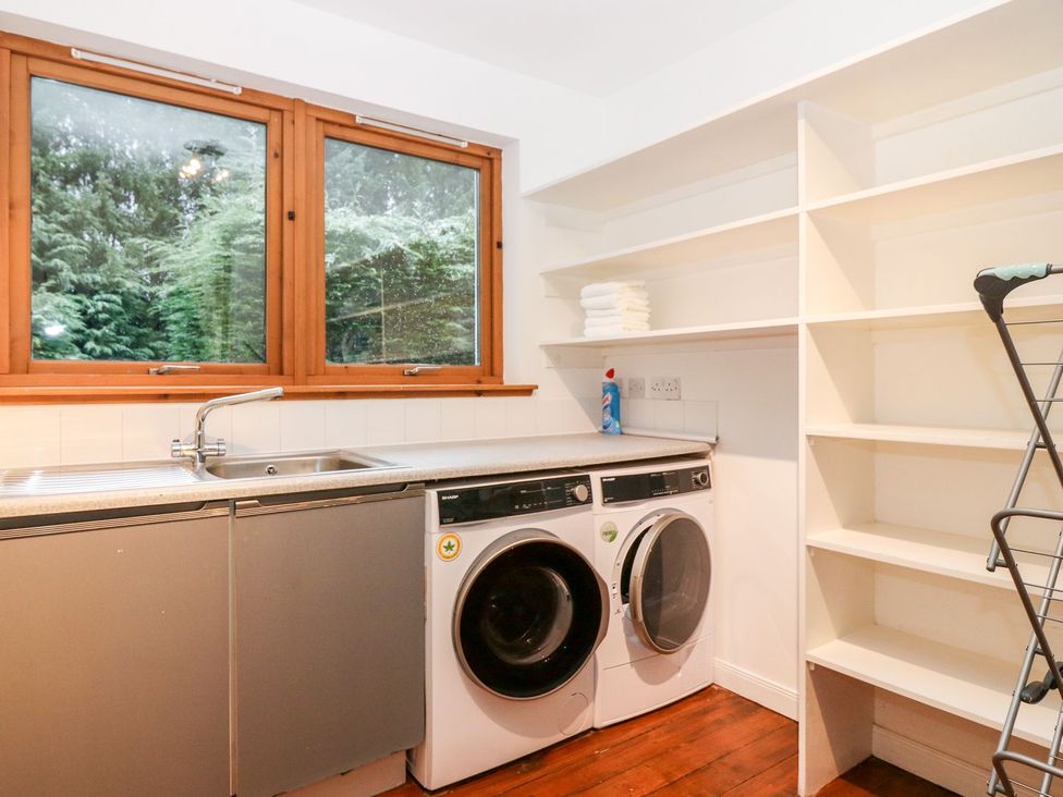 A laundry room with a washing machine and tumble dryer at Boat House in Aberdeen
