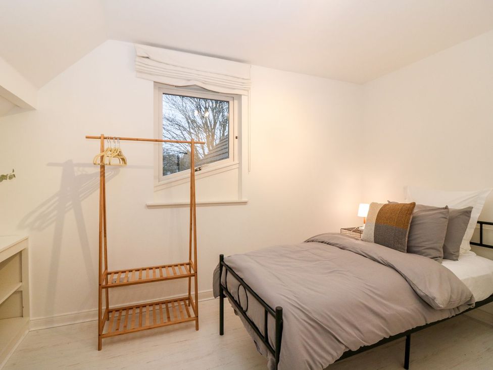 A bedroom with a bed and a clothes rack at Boat House in Aberdeen