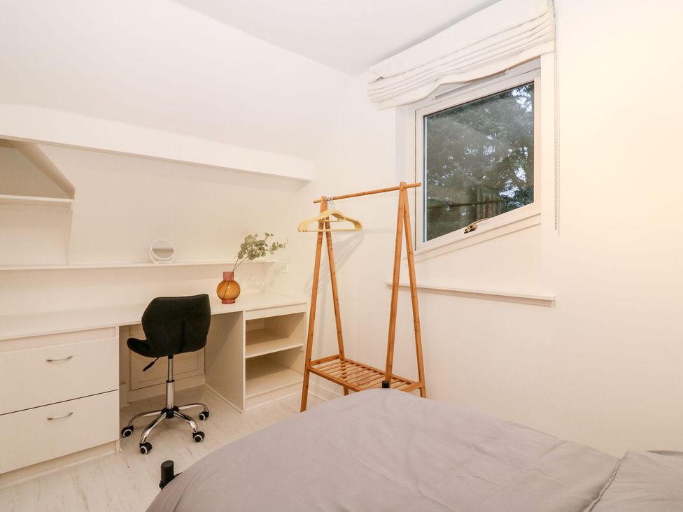 A bedroom with a desk and chair at Boat House in Aberdeen