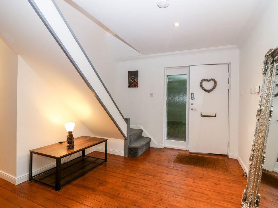 A hallway with a staircase and a table at Boat House in Aberdeen