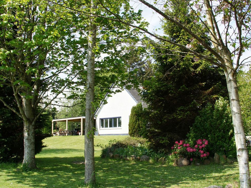 A house surrounded by trees and flowers at Boat House in Aberdeen