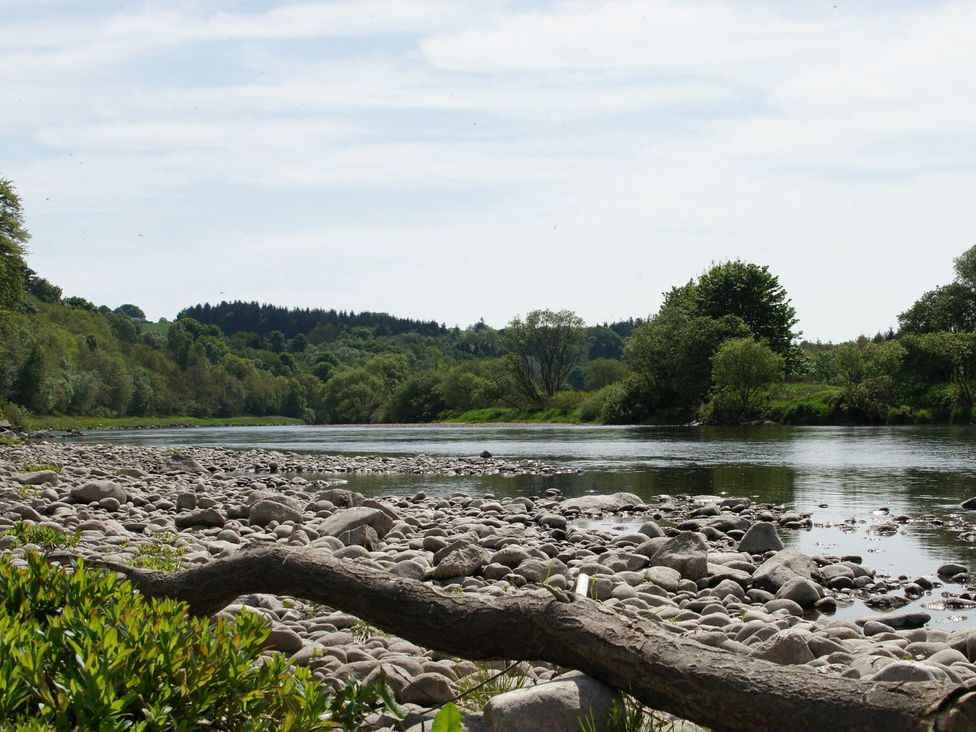 A river with rocks and trees along the shoreline at Boat House Aberdeen