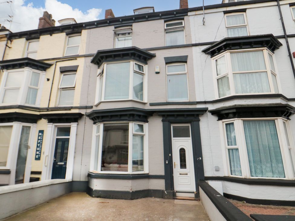 A building exterior with multiple windows and a door at 12 Neptune Terrace in Bridlington
