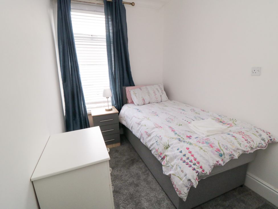A bedroom with single bed and drawer unit at 12 Neptune Terrace in Bridlington