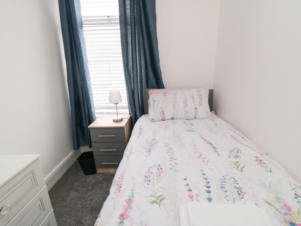 A bedroom with a bed and nightstand at 12 Neptune Terrace Bridlington