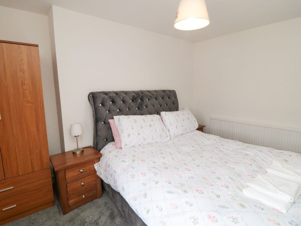 A bedroom with a bed and wardrobe at 12 Neptune Terrace in Bridlington
