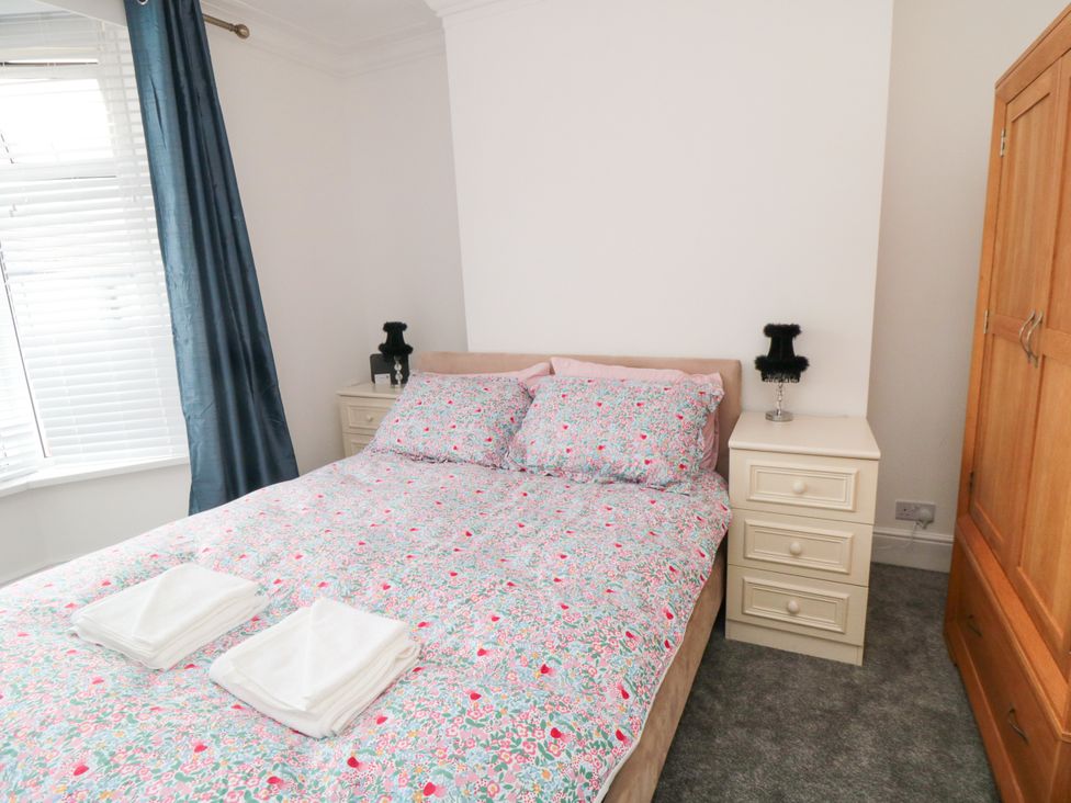 A bedroom with a bed and bedside tables at 12 Neptune Terrace in Bridlington