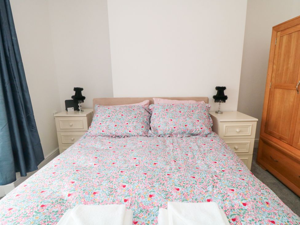 A bedroom with a bed and bedside tables at 12 Neptune Terrace in Bridlington