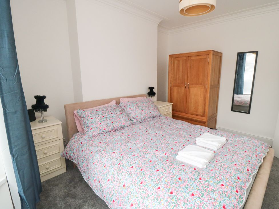 A bedroom with a bed and wardrobe at 12 Neptune Terrace in Bridlington
