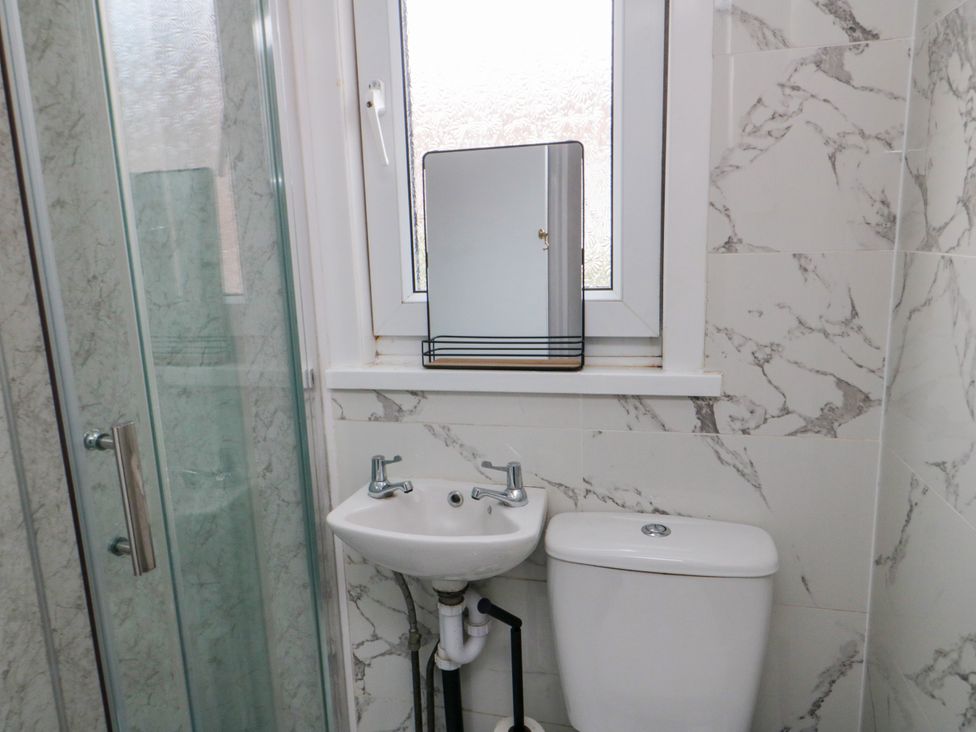 A bathroom with a shower, sink, and toilet at 12 Neptune Terrace Bridlington