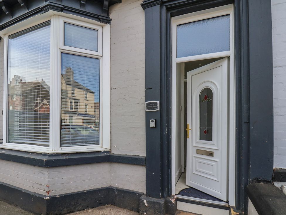 An entrance with a door and window at K & J Holiday House in Bridlington