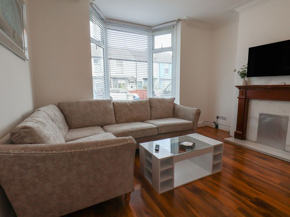 A living room with a sofa and coffee table at K & J Holiday House in Bridlington