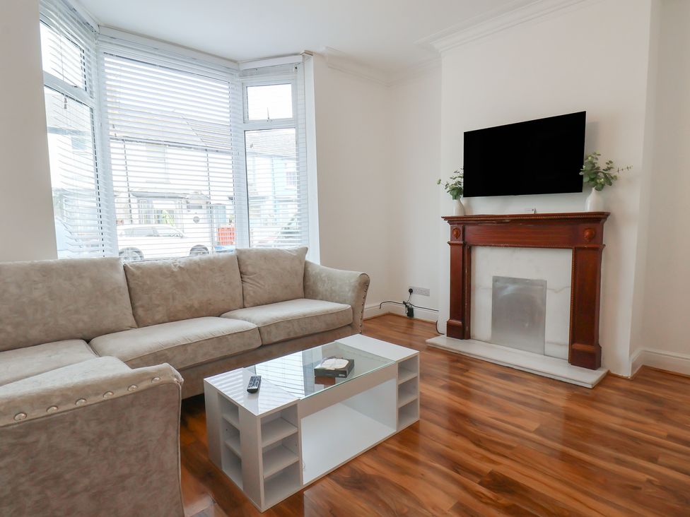 A living room with a sofa and television at K & J Holiday House in Bridlington