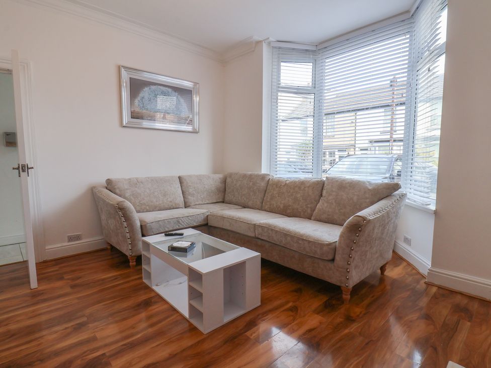 A living room with a sofa and coffee table at K & J Holiday House in Bridlington