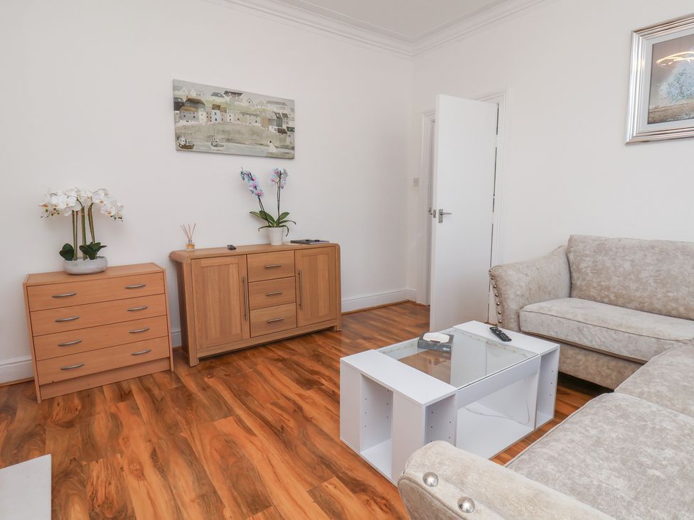 A living room with a sofa and coffee table at K & J Holiday House in Bridlington