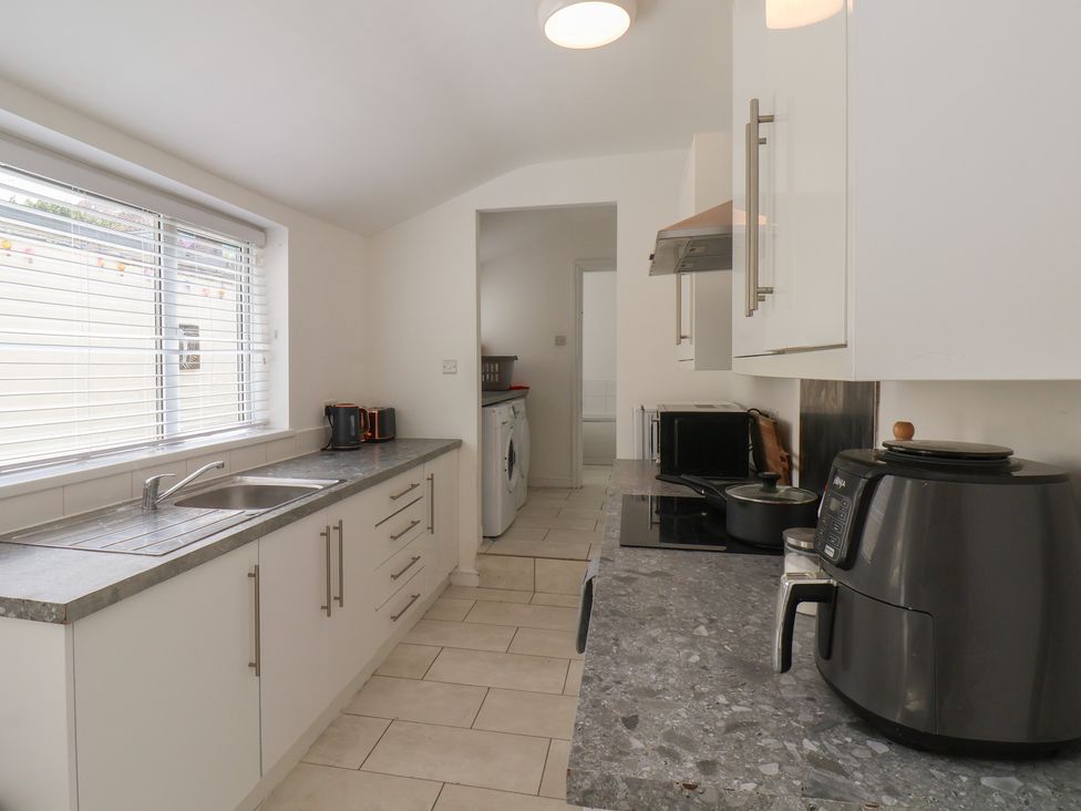 A kitchen with a sink and appliances at K & J Holiday House in Bridlington