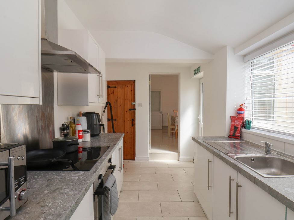 A kitchen with a stove and sink at K & J Holiday House in Bridlington