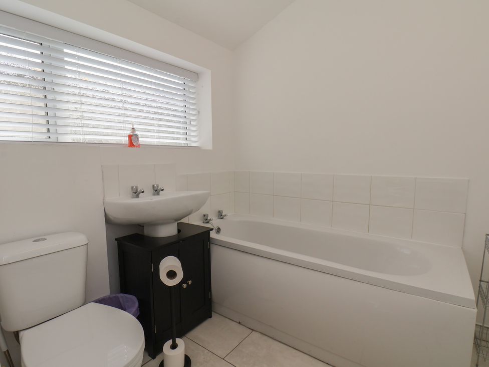A bathroom with a sink and bathtub at K & J Holiday House in Bridlington
