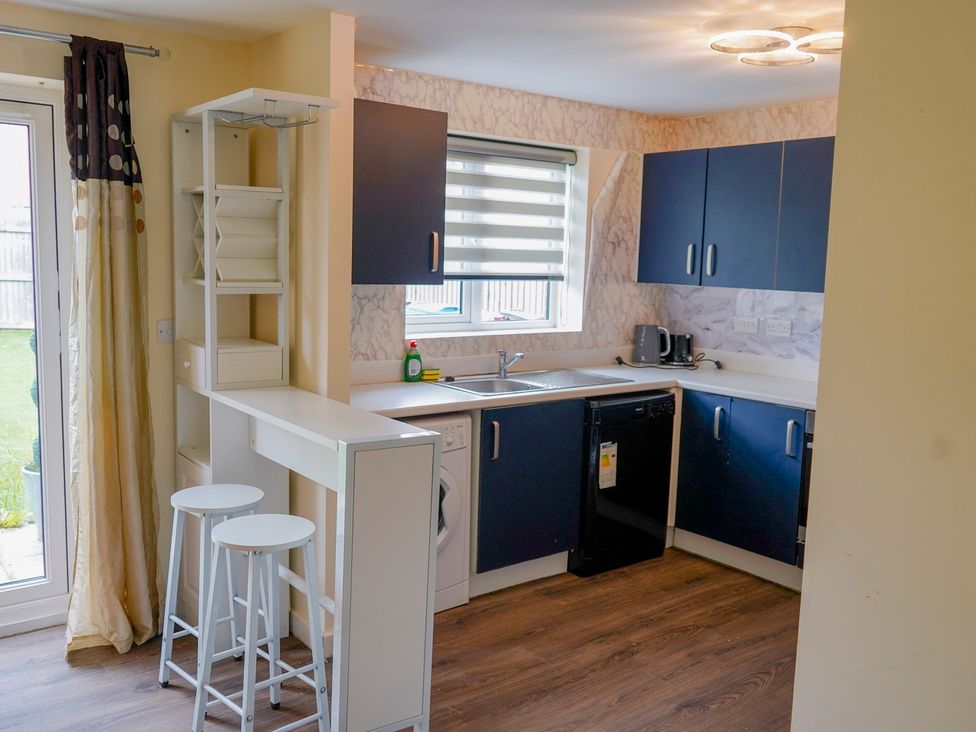 A kitchen with a sink and appliances at 4 Britannia Street in Salford