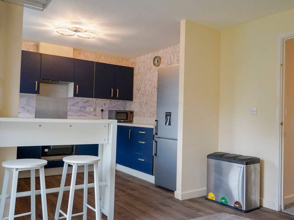 A kitchen with a refrigerator and microwave at 4 Britannia Street Salford