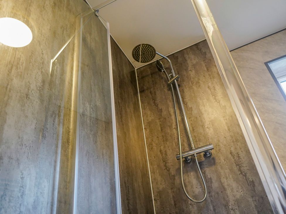 A shower with glass partition and controls at 4 Britannia Street Salford