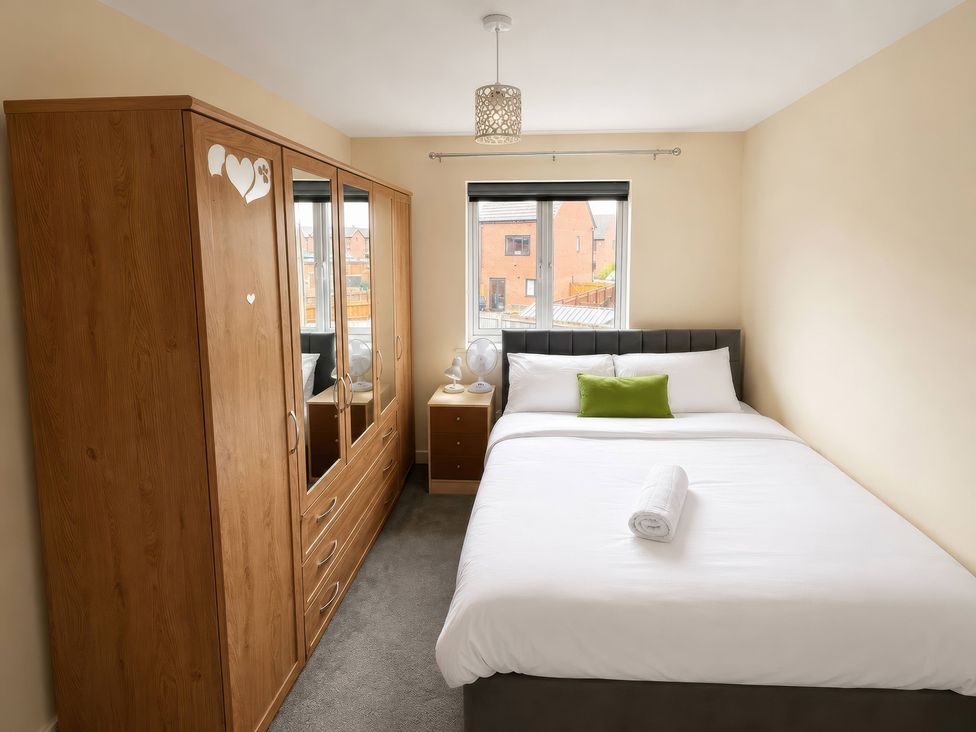 A bedroom with a bed and wardrobe at 4 Britannia Street Salford