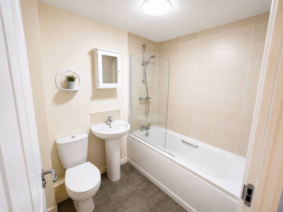A bathroom with a bathtub, toilet, and sink at 4 Britannia Street Salford