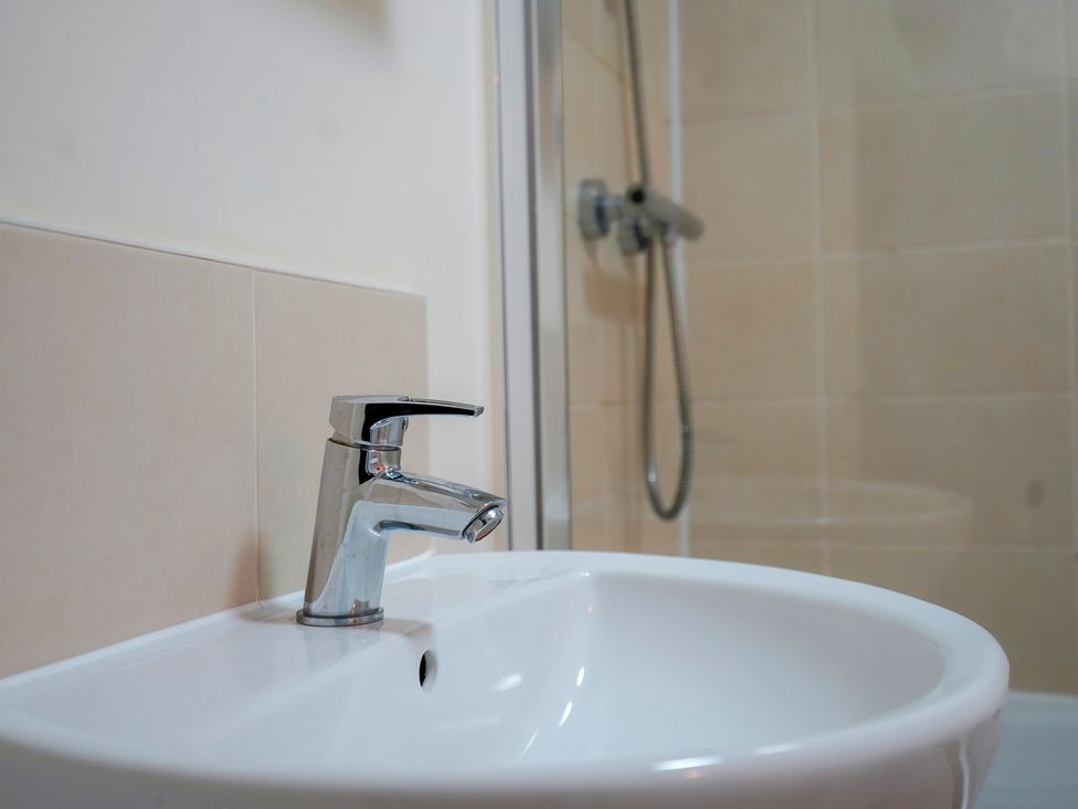 A sink with a faucet and a shower in the bathroom at 4 Britannia Street Salford