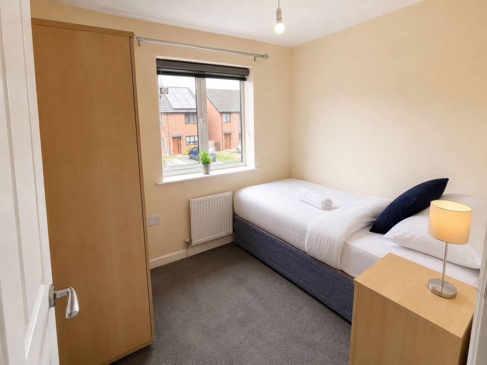 A bedroom with a bed and window view at 4 Britannia Street in Salford